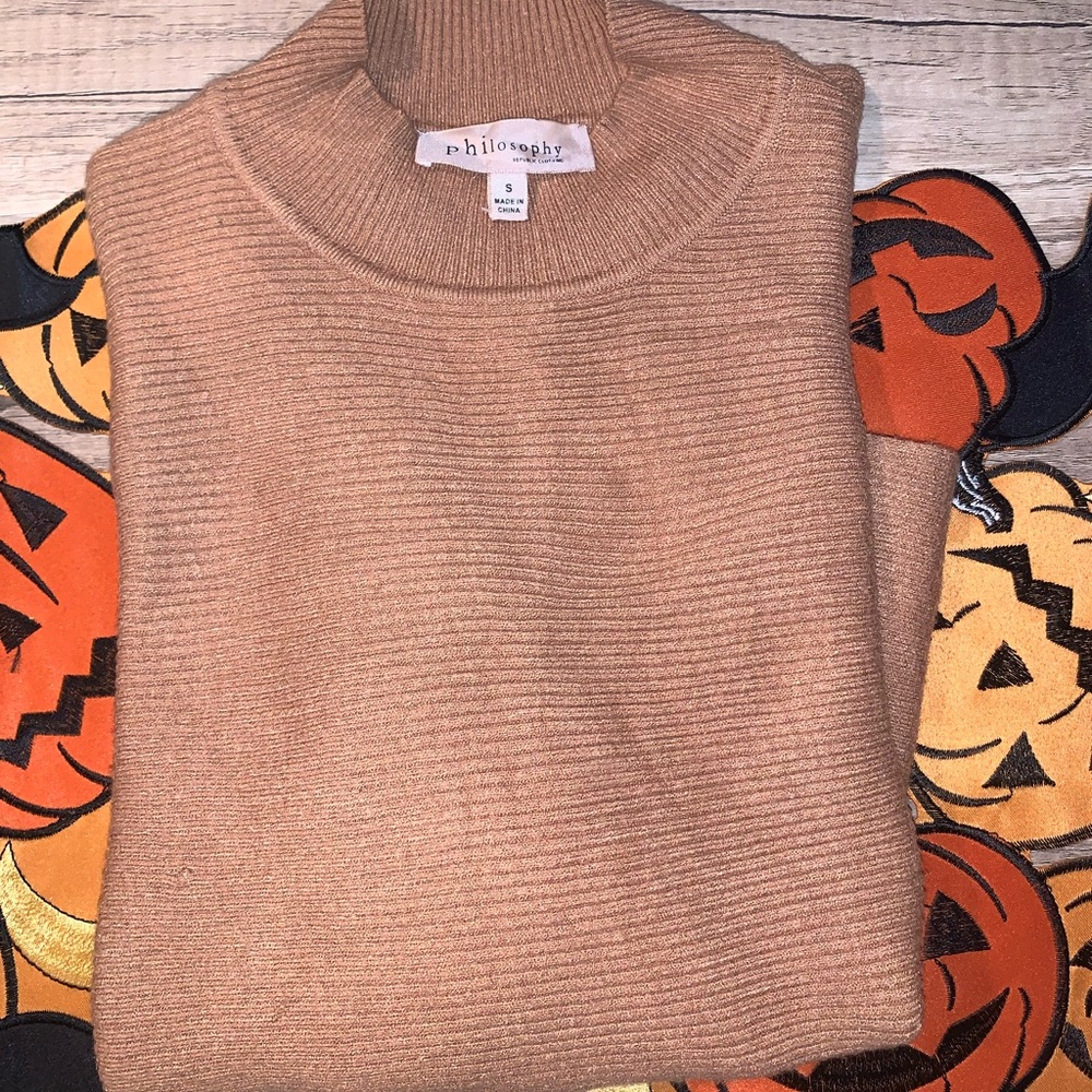Philosophy tan sweater.